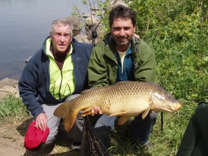 Photo of Lawrence holding his 33lb 8oz Carp with Miles