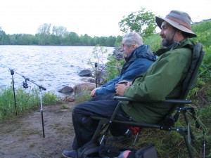 Photo of Miles and Lawrence sitting with their rods on the rod-rests